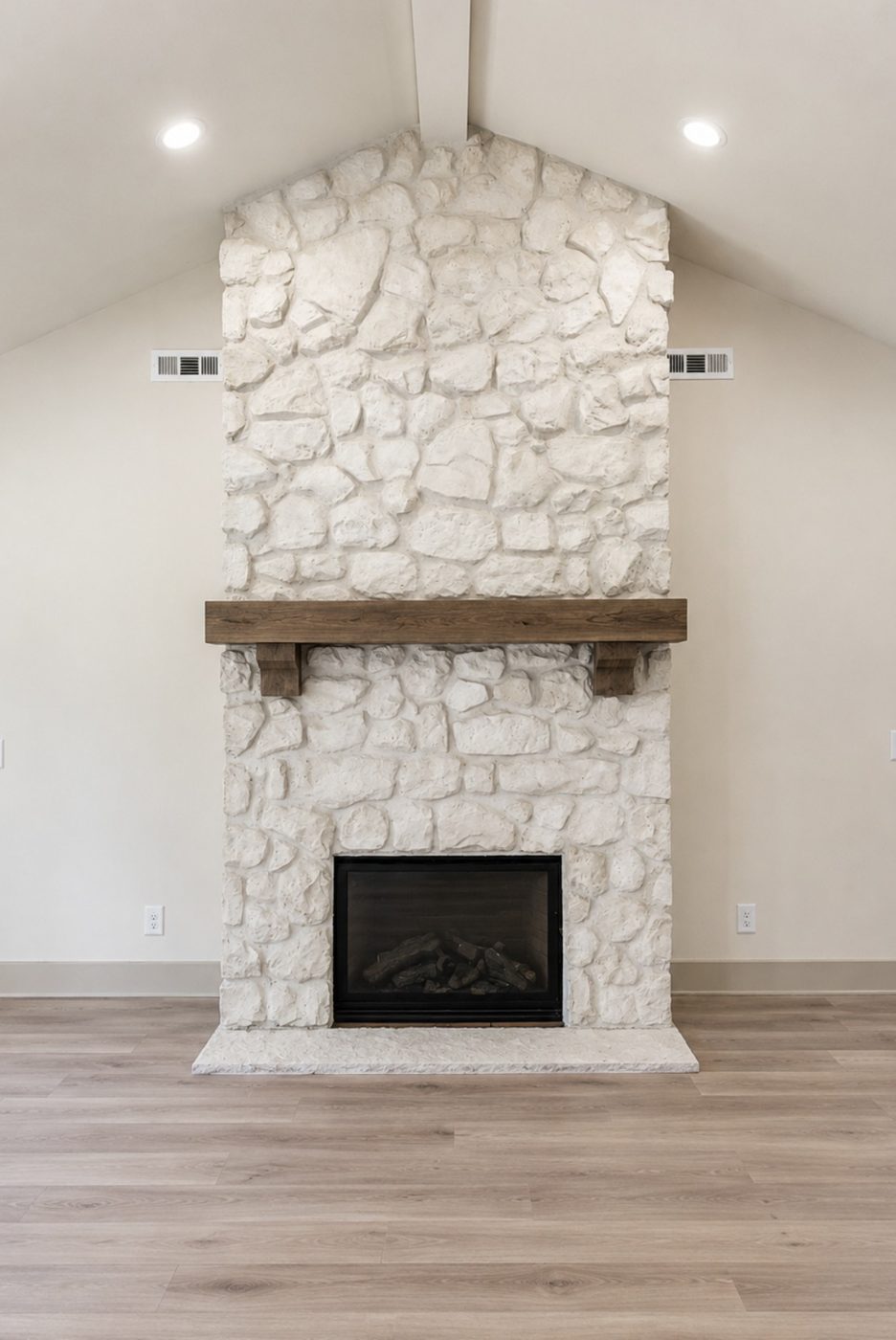 Chopped limestone fireplace with reclaimed beam mantel